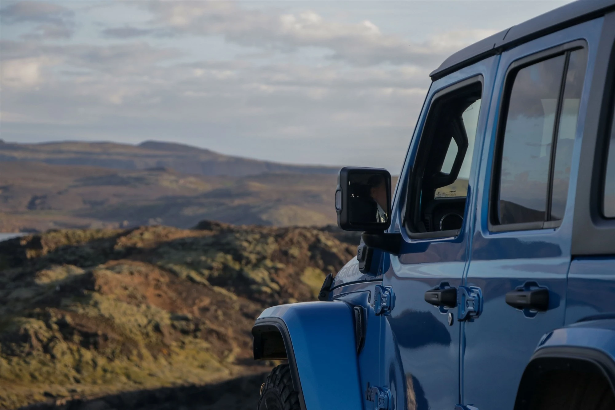 Jeep Wrangle Rubicon 4x4 rental car and mountain in Iceland.